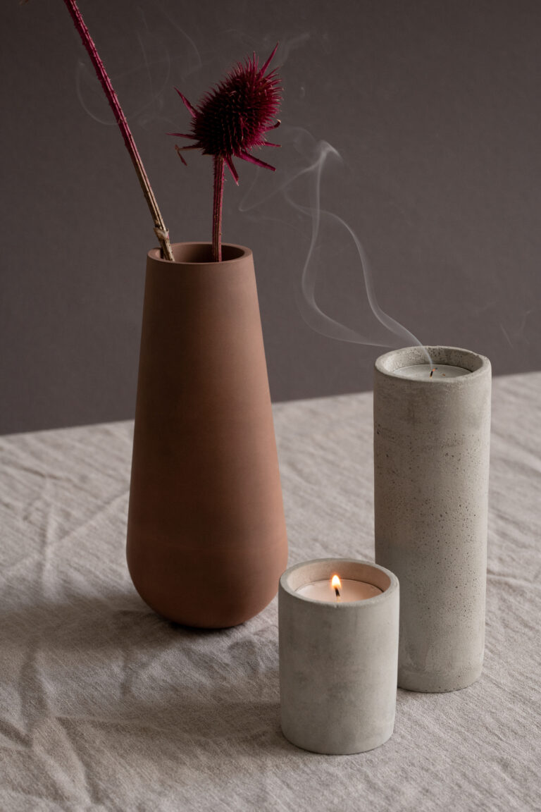 Two ceramic vessels with incense smoke against a dark background, a calm bedside vignette